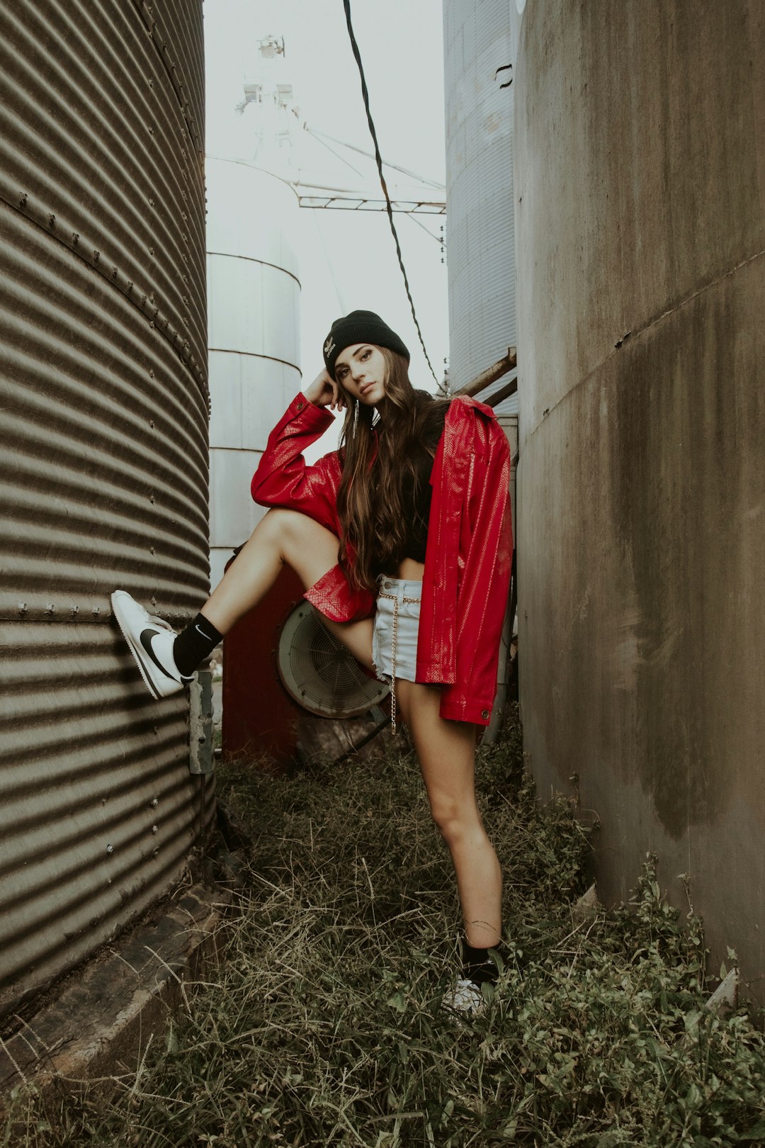 woman in red long sleeve shirt and white and black leather backpack standing beside woman in during