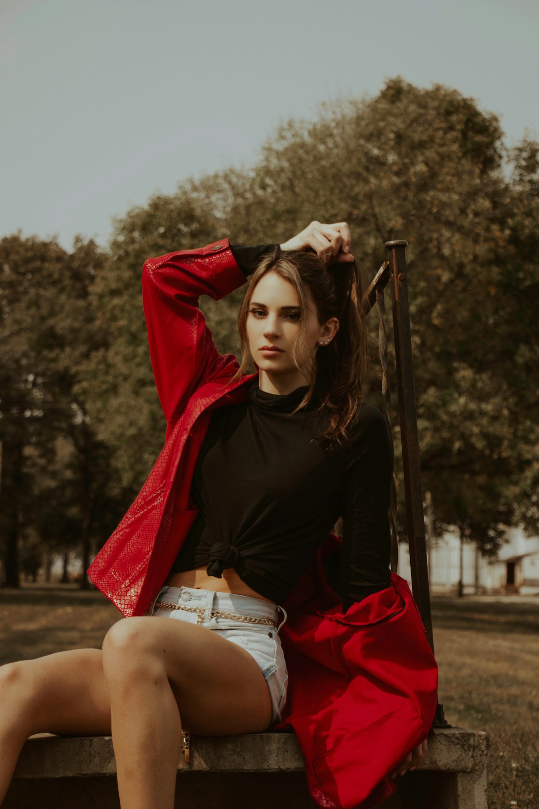 woman in black shirt and white shorts sitting on brown wooden ladder