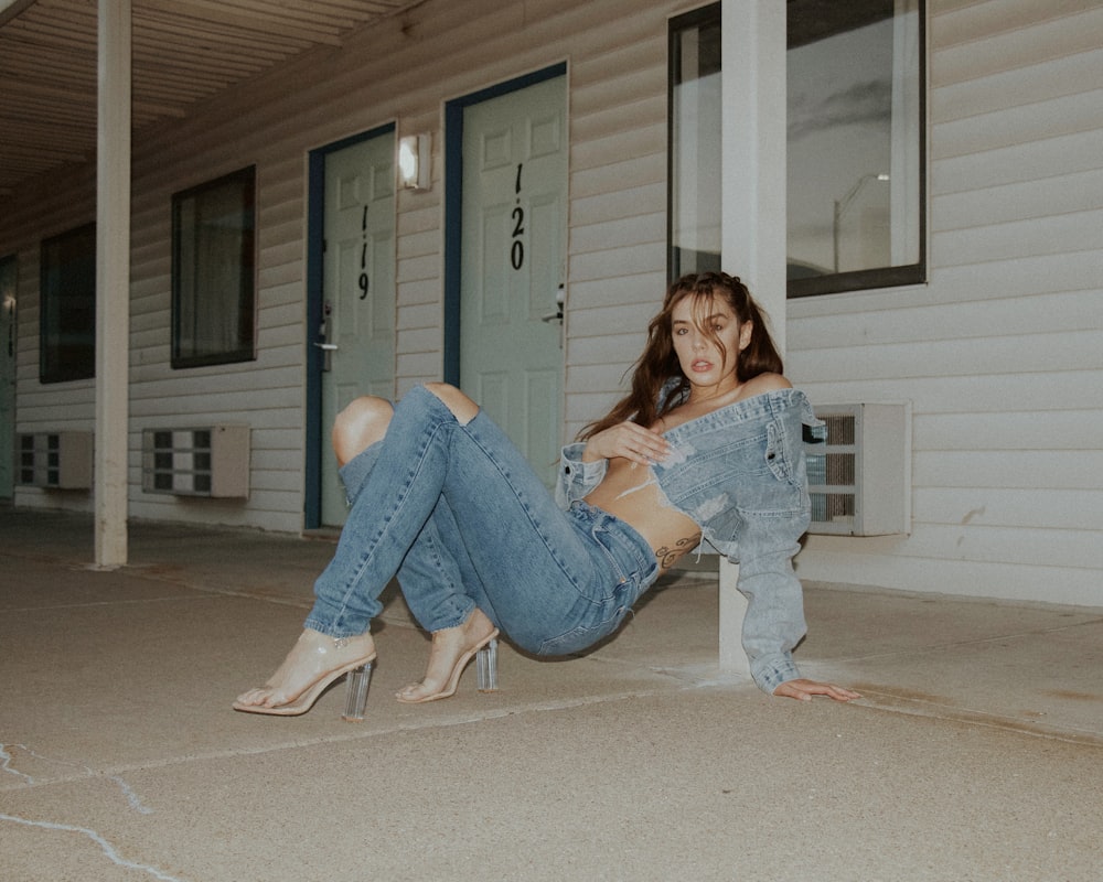 woman in blue denim jeans sitting on floor