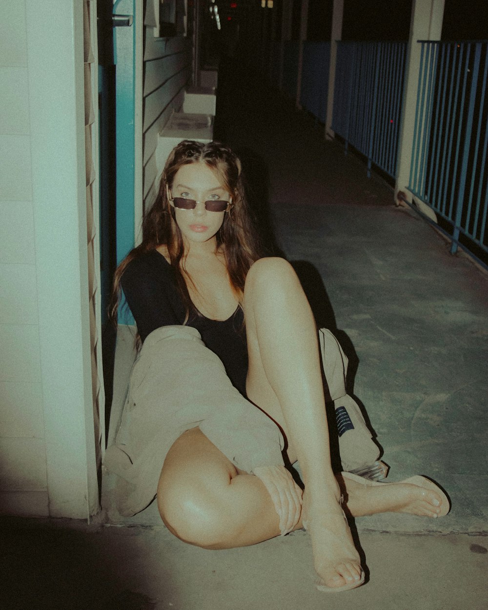 woman in blue tank top sitting on floor