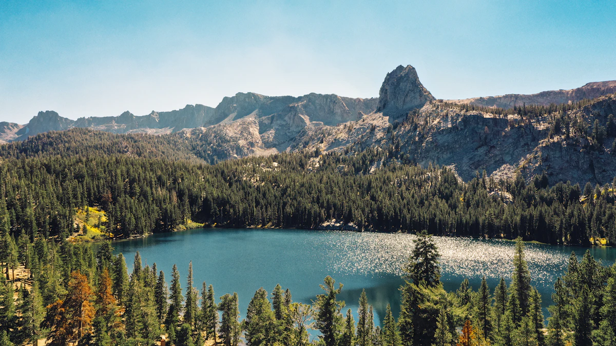 Lake George near Mammoth Lakes, ringed by pines under a jagged granite ridge and a pointed crag