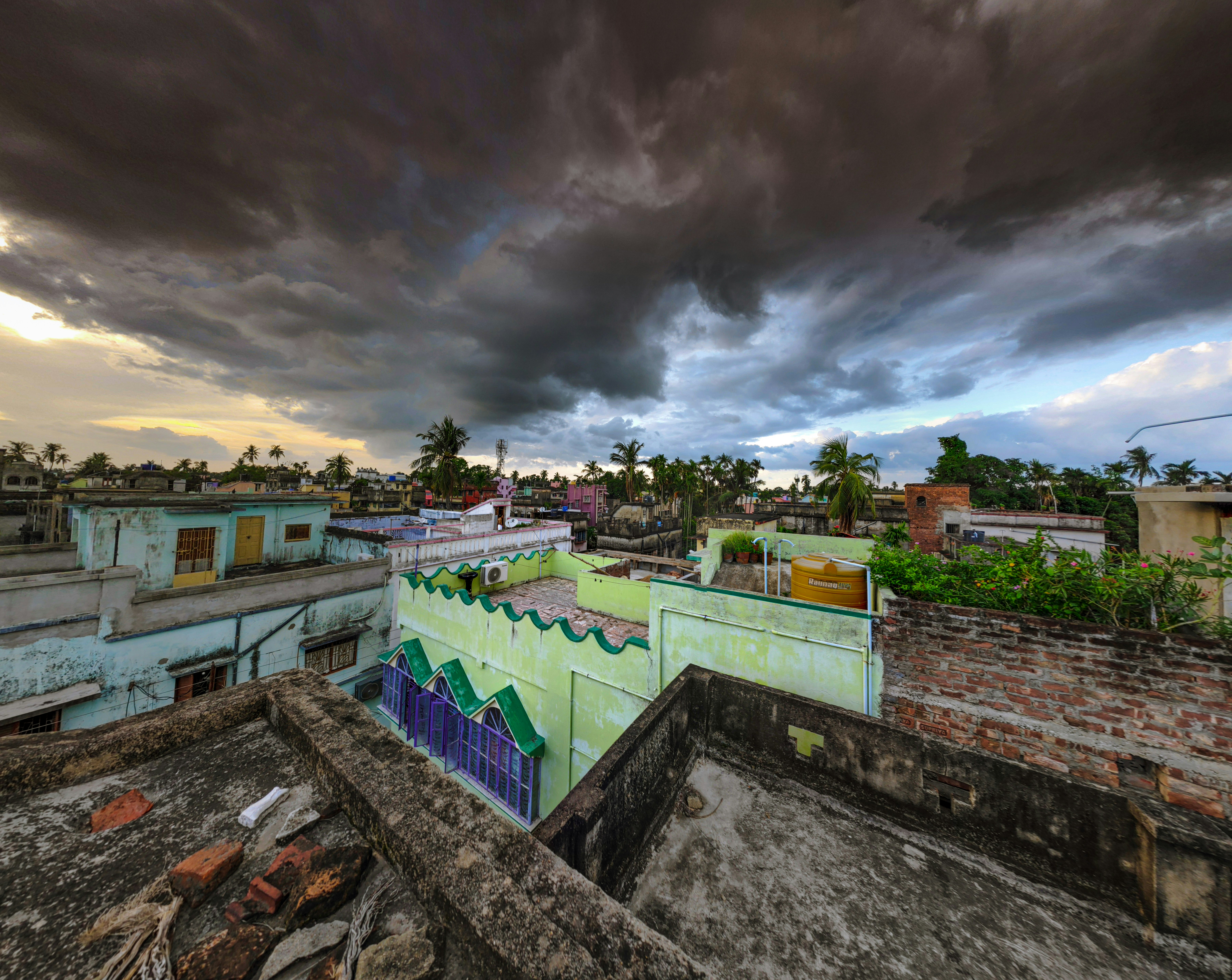 houses under gray cloudy sky during daytime