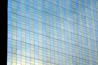 Close-up of tempered glass panel reflecting sunlight in a modern setting