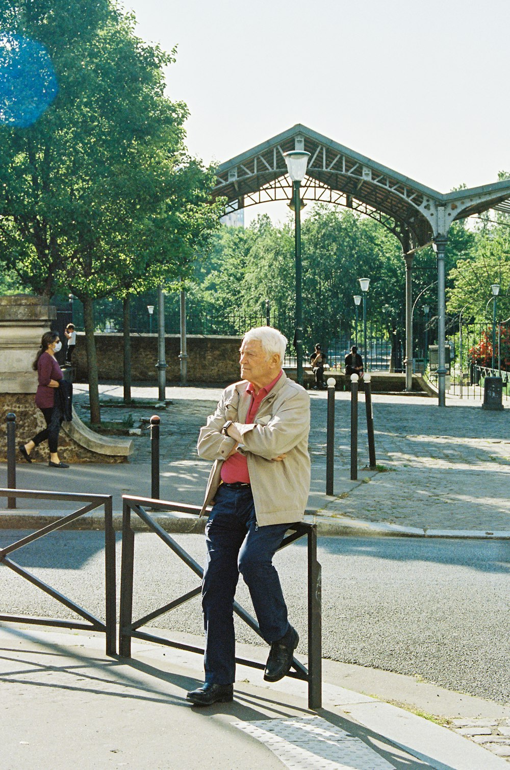 woman in pink coat standing on gray concrete pavement during daytime