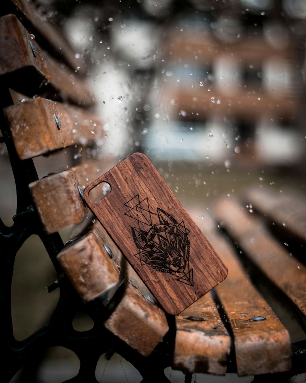 brown wooden bench with water droplets