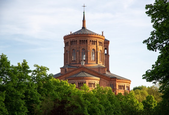 The main campus building of Covenant International Bible College set against a clear blue sky.