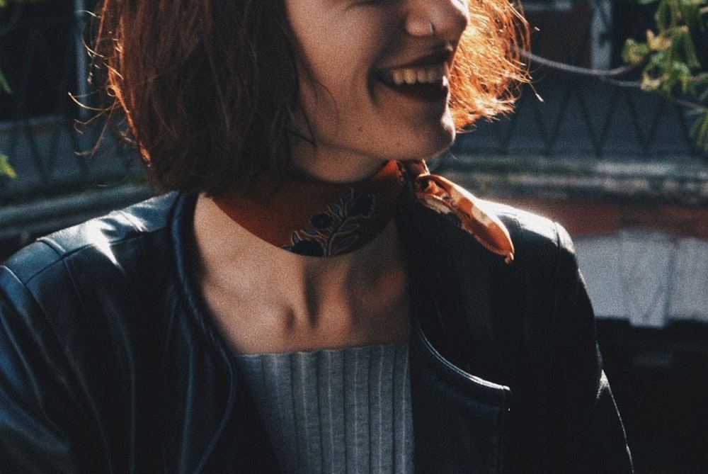 woman in black jacket with brown and black floral tattoo on her left shoulder