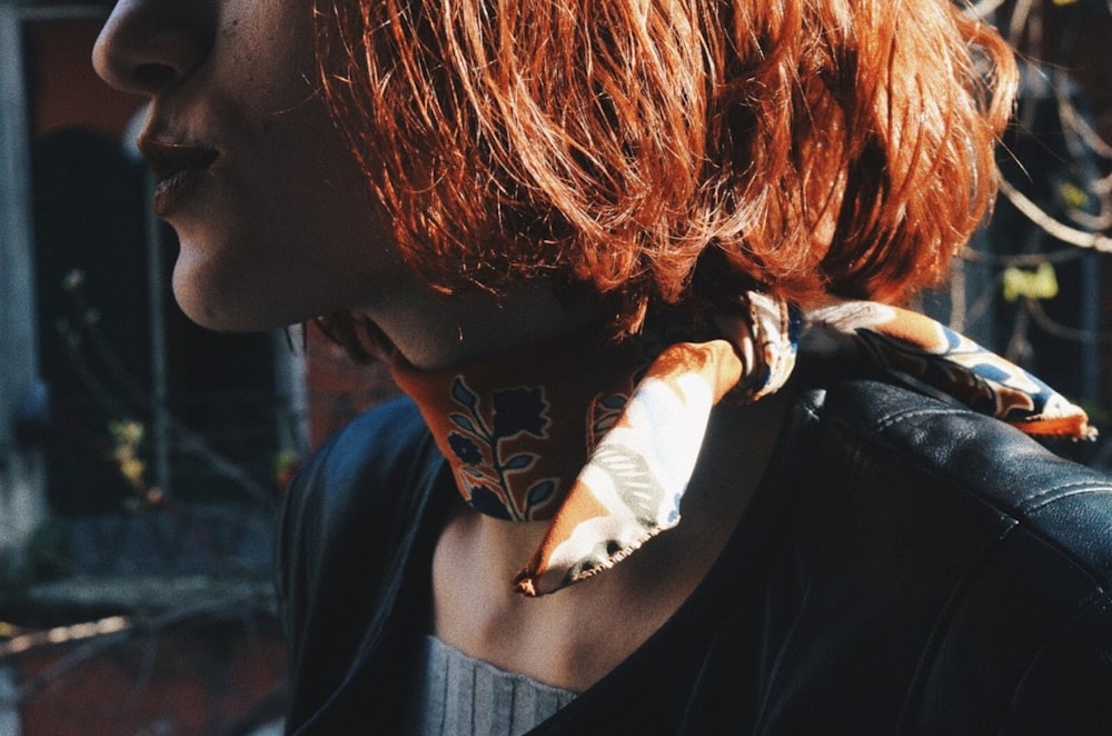 woman in black shirt with white and brown bird on her head