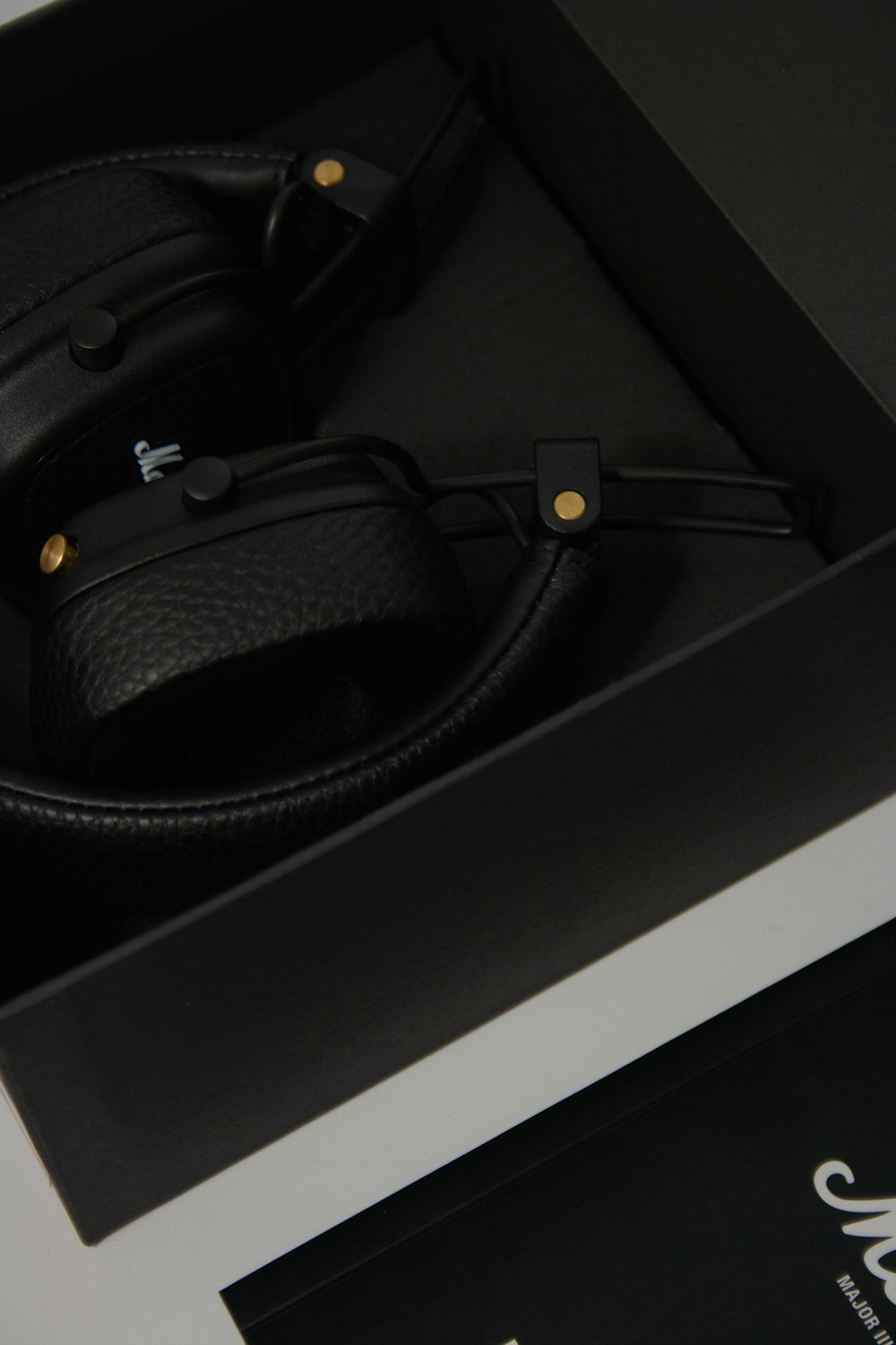 black corded headphones on black box