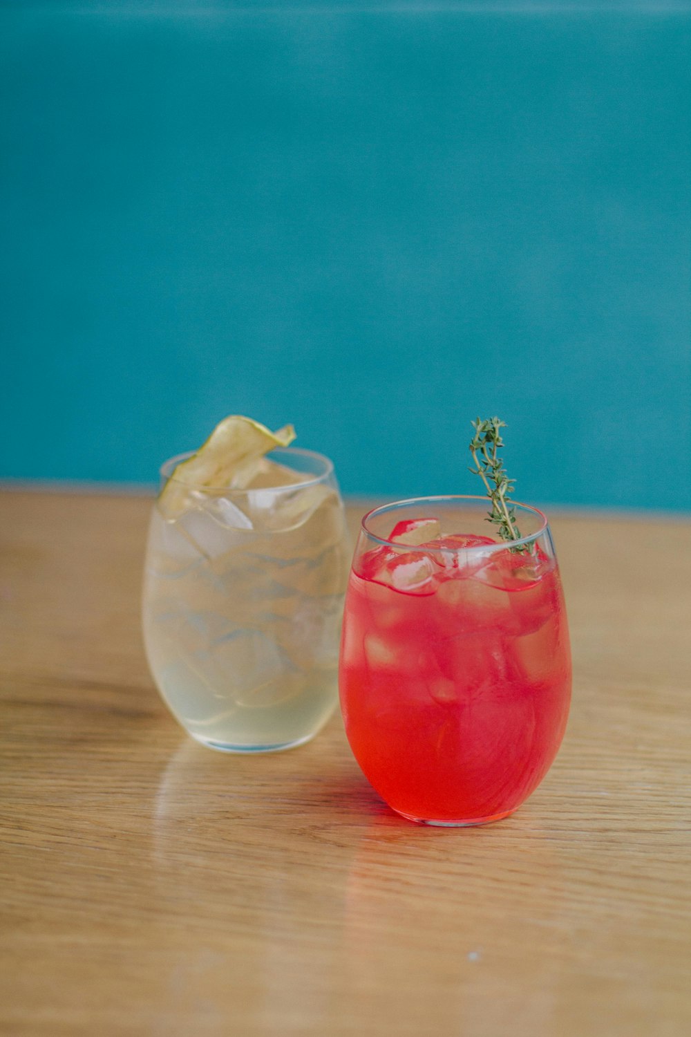 clear drinking glass with red liquid and ice