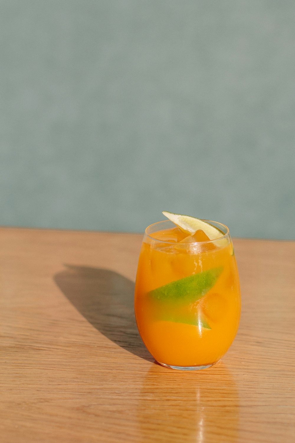 orange juice in clear drinking glass