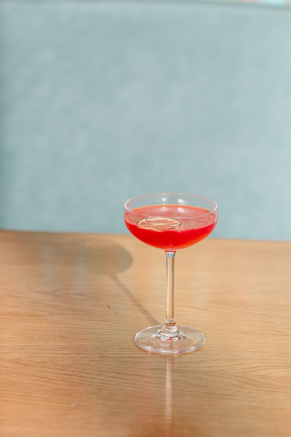 red wine in clear wine glass on brown wooden table