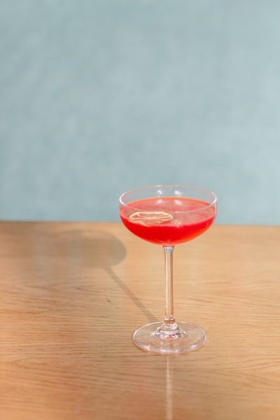 red wine in clear wine glass on brown wooden table