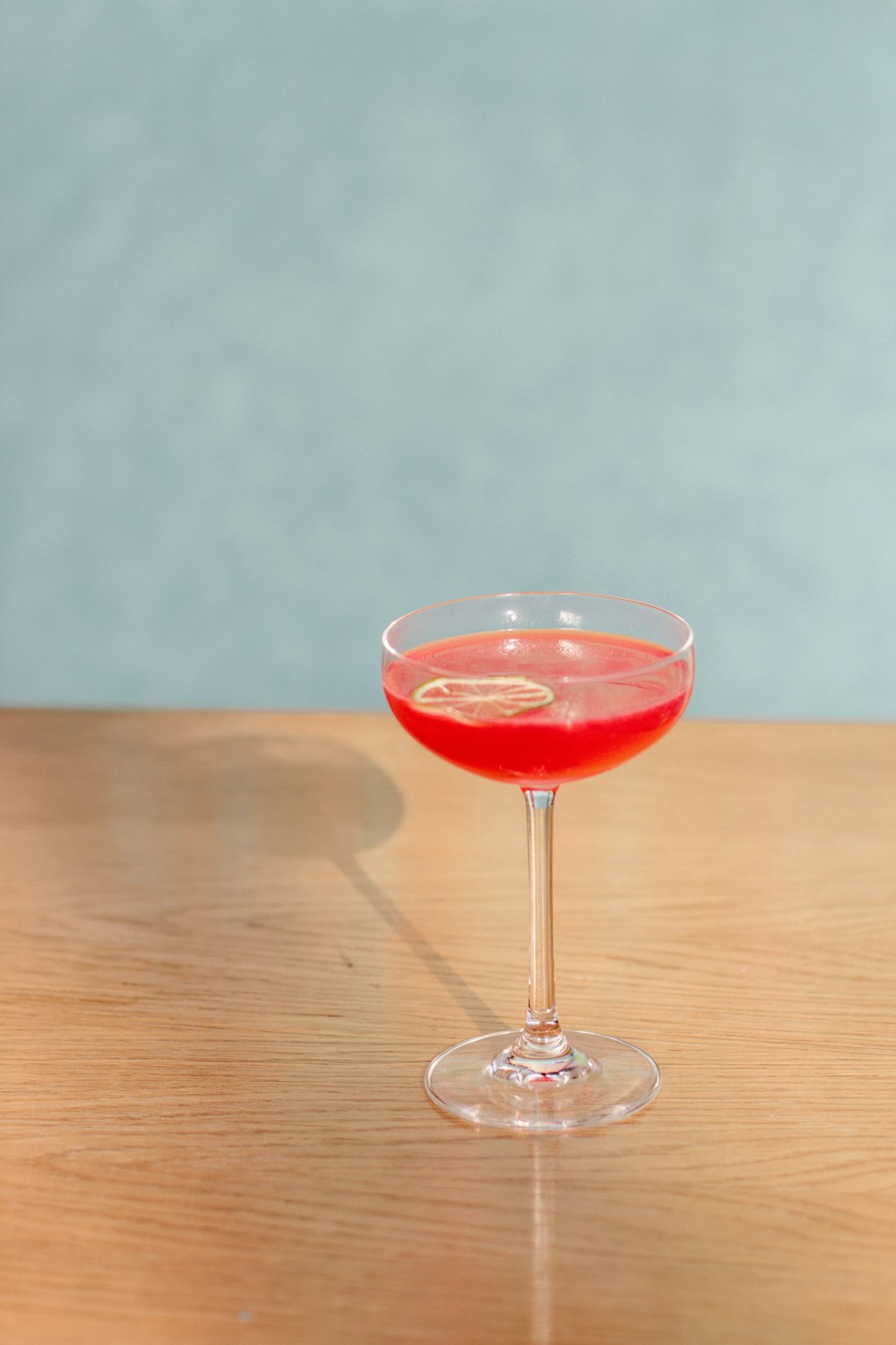 red wine in clear wine glass on brown wooden table