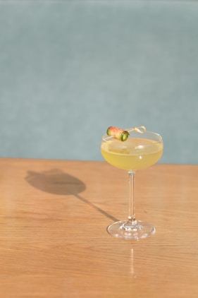 yellow liquid in clear cocktail glass