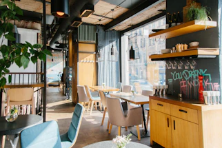 Cozy modern cafe interior with warm lighting and industrial design elements.