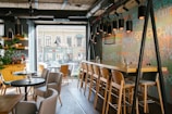 A chic cafe interior with inviting seating and artistic decor.