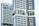 Modern high-rise residential buildings with a unique architectural design featuring prominent balconies and integrated greenery. The structures have a geometric pattern with large windows and white, sleek facades.
