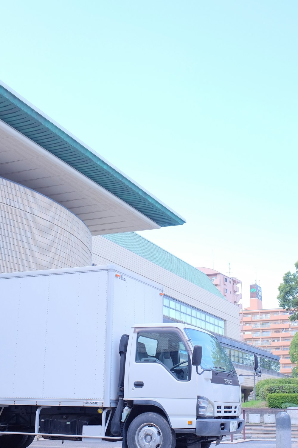 white van parked near white building during daytime