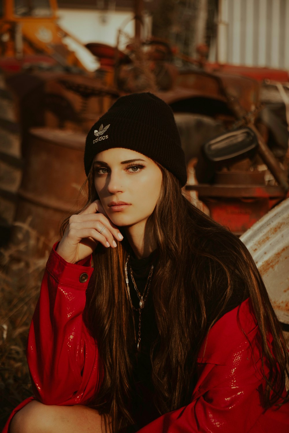woman in black knit cap and red leather jacket