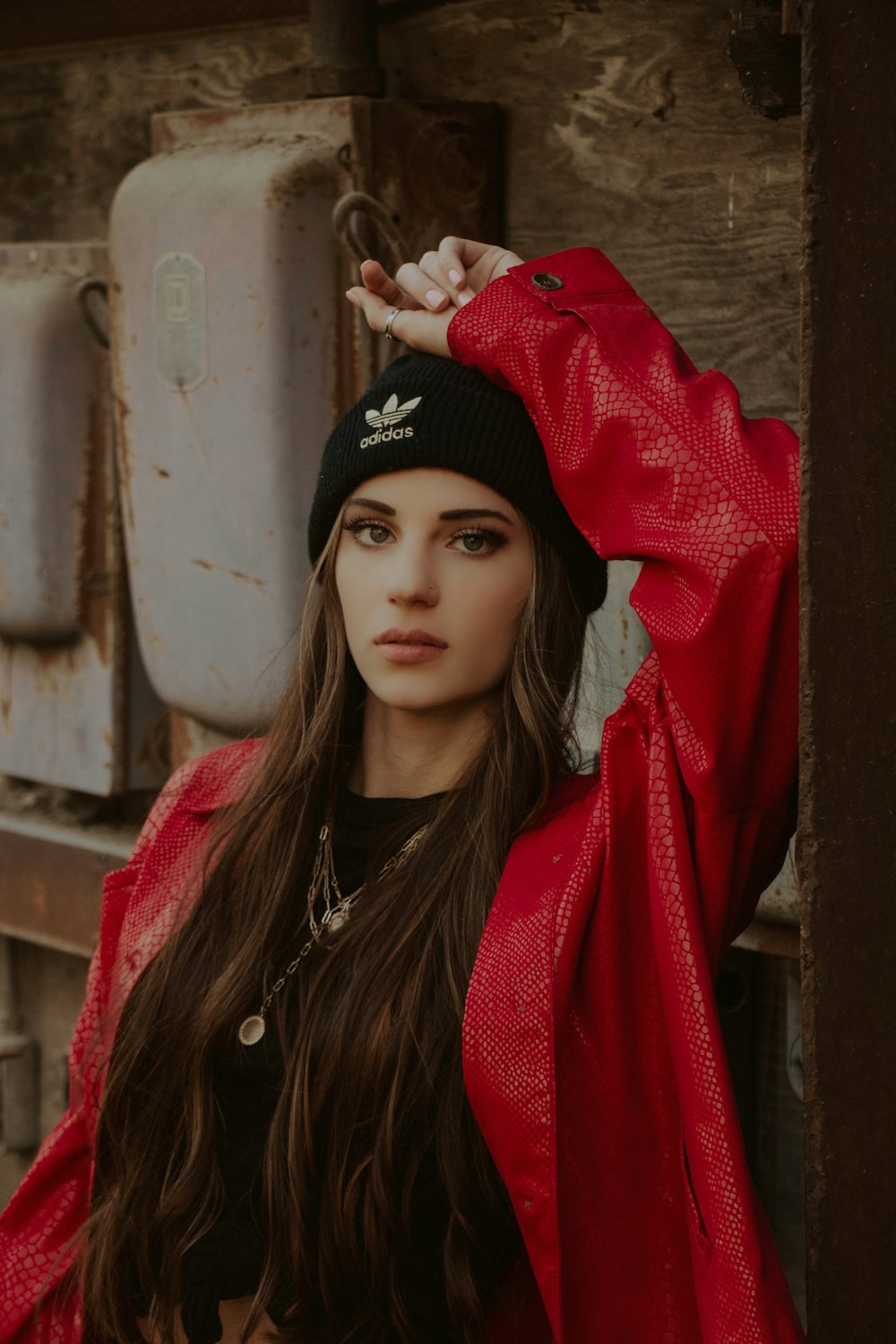 woman in black knit cap and red scarf