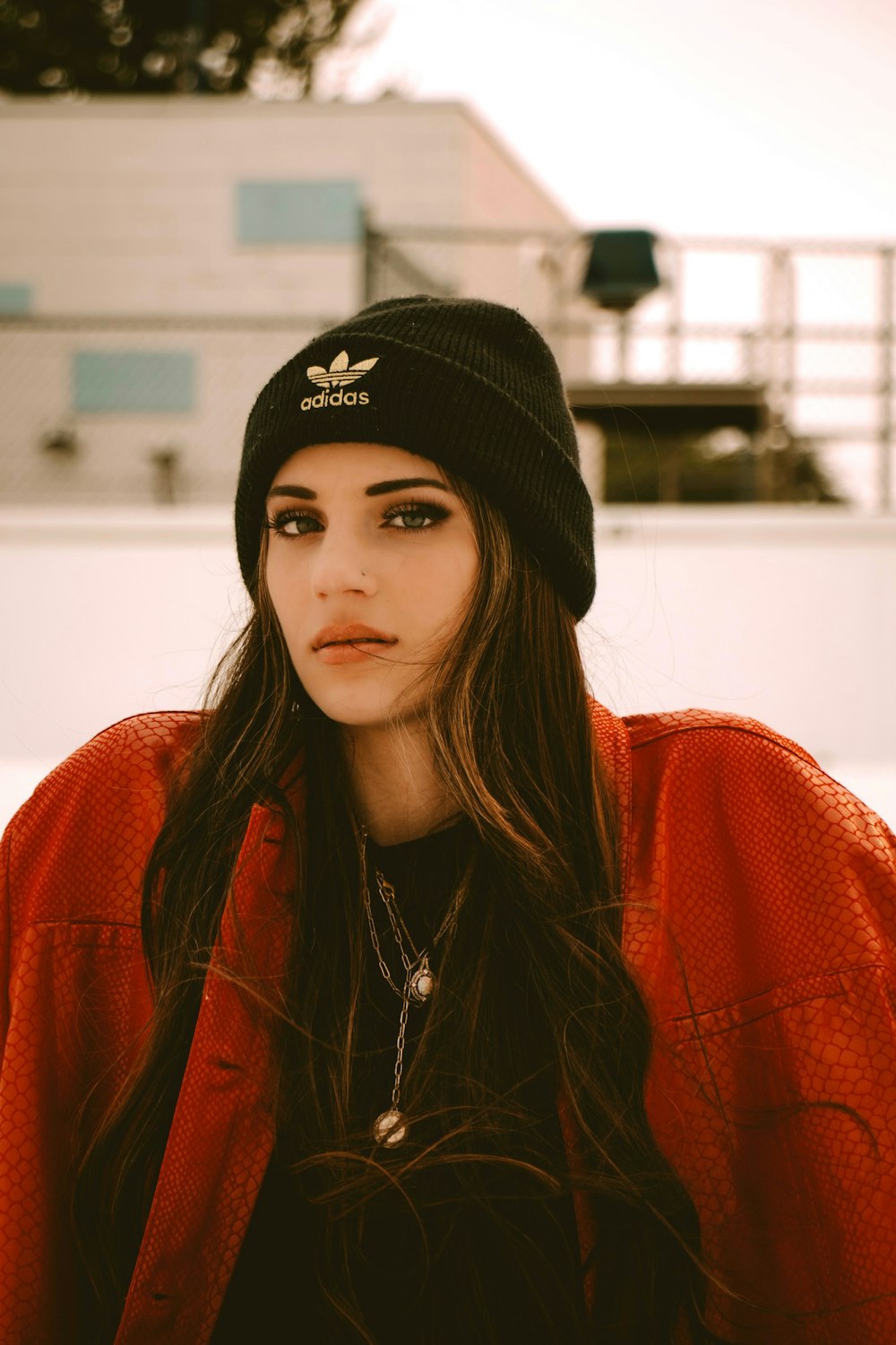 woman in black knit cap and red and black plaid shirt