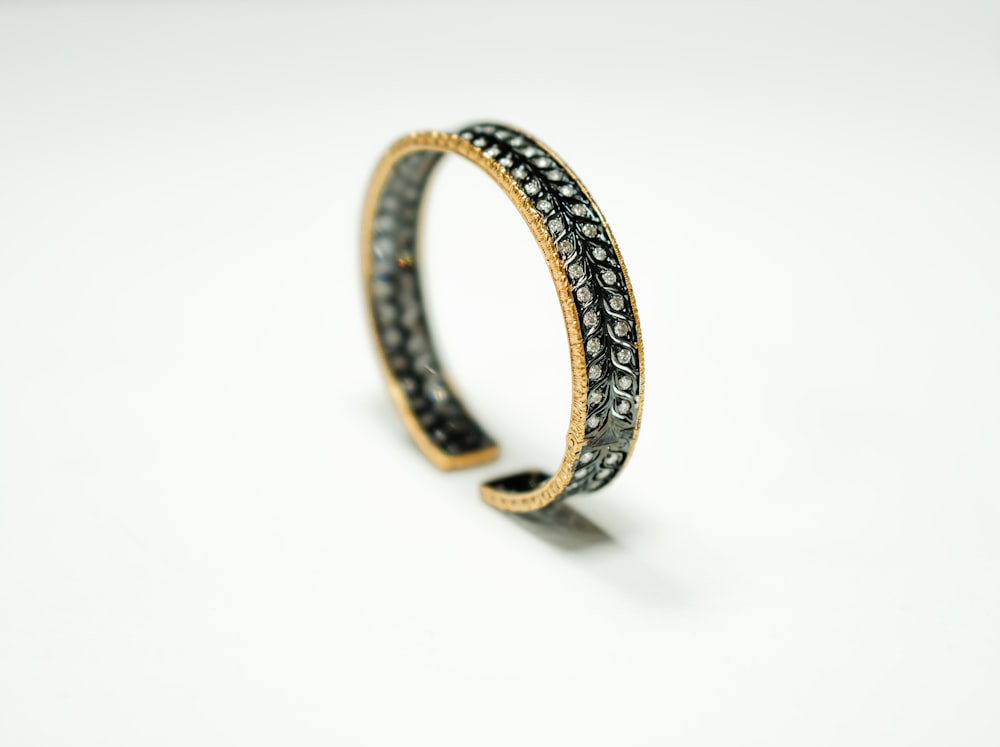gold and silver ring on white surface