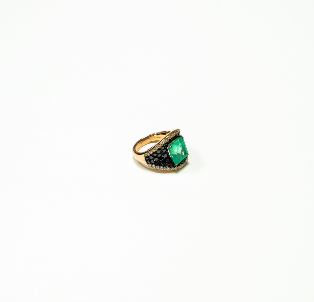 Emerald-cut emerald ring set with diamond shoulders