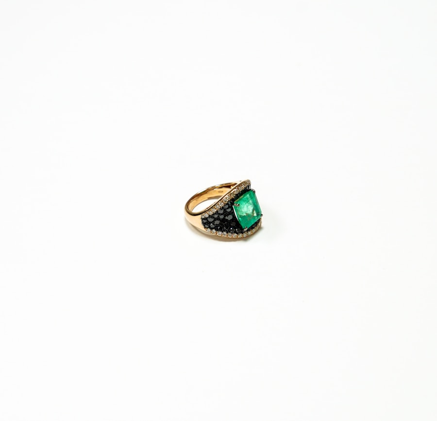 Sade cocktail ring with emerald-cut emerald center stone