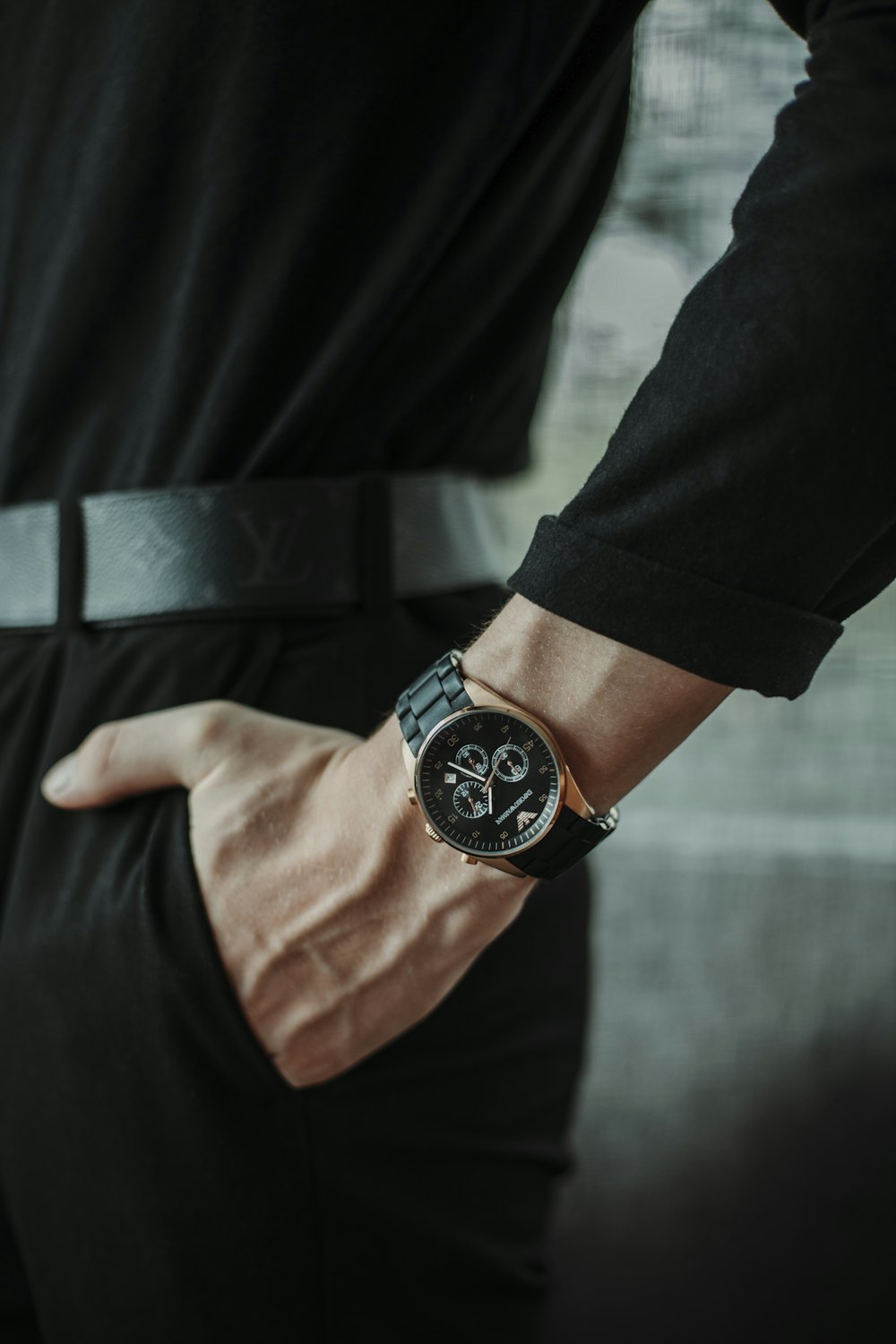 person wearing black round analog watch