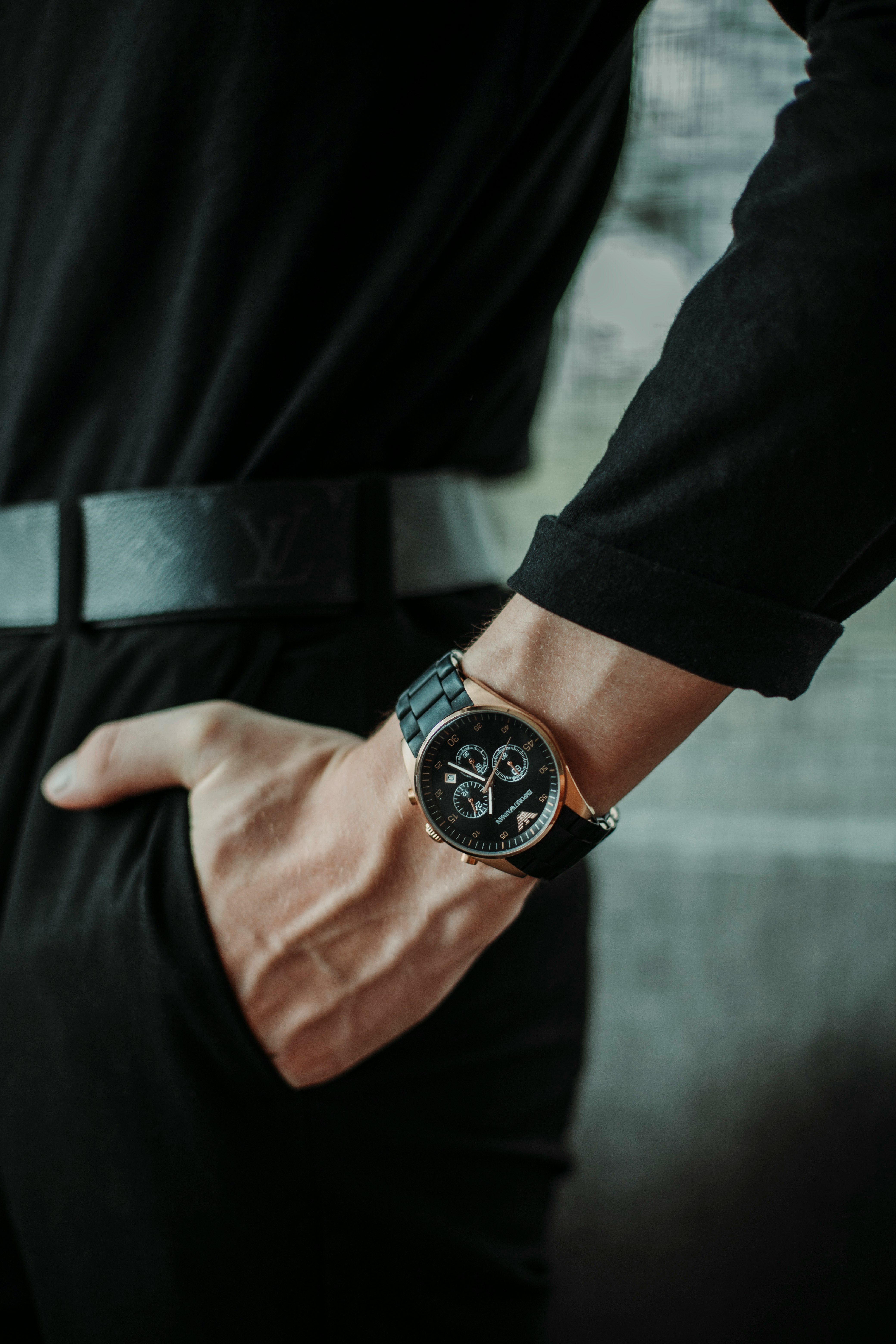 person wearing black round analog watch