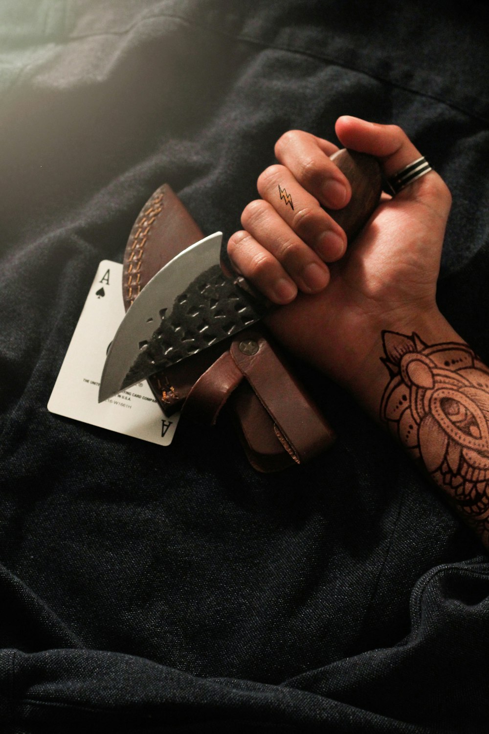 person holding brown and silver studded leather belt