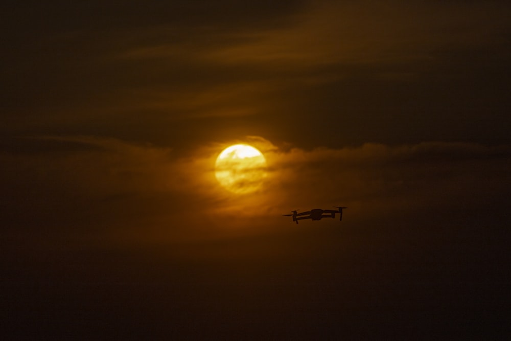 airplane flying during golden hour