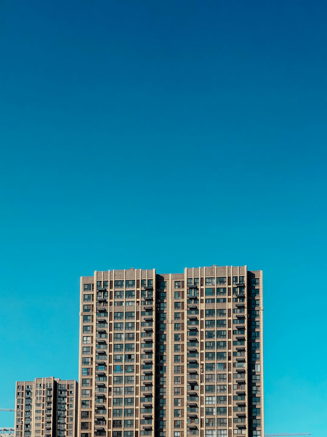 white and blue high rise building under blue sky during daytime