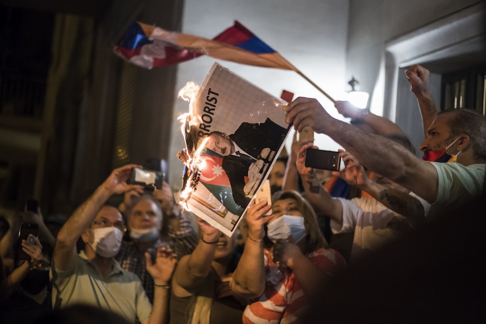 people holding blue and white flag during daytime