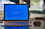 macbook pro on brown wooden table