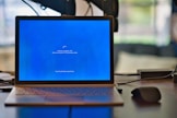macbook pro on brown wooden table