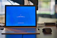 macbook pro on brown wooden table