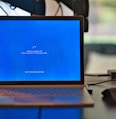 macbook pro on brown wooden table