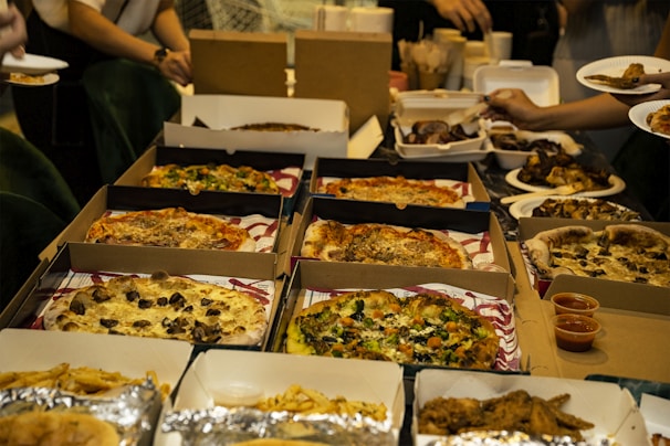 An assortment of pizzas displayed on a wooden table.