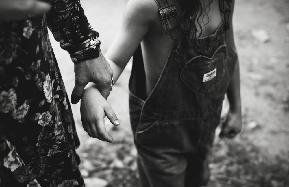 grayscale photo of woman in black tank top and denim jeans