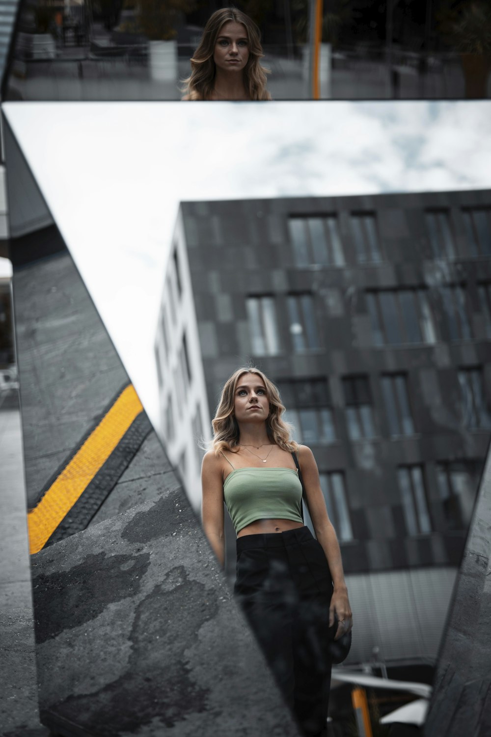 woman in green tube dress standing on gray concrete floor during daytime