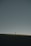 person in red shirt walking on brown field under gray sky during daytime