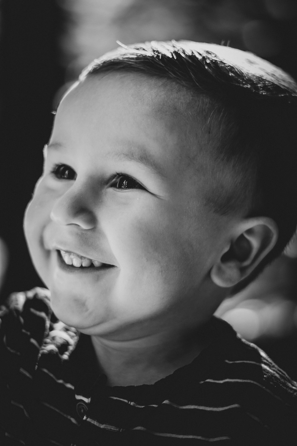 grayscale photo of boy smiling