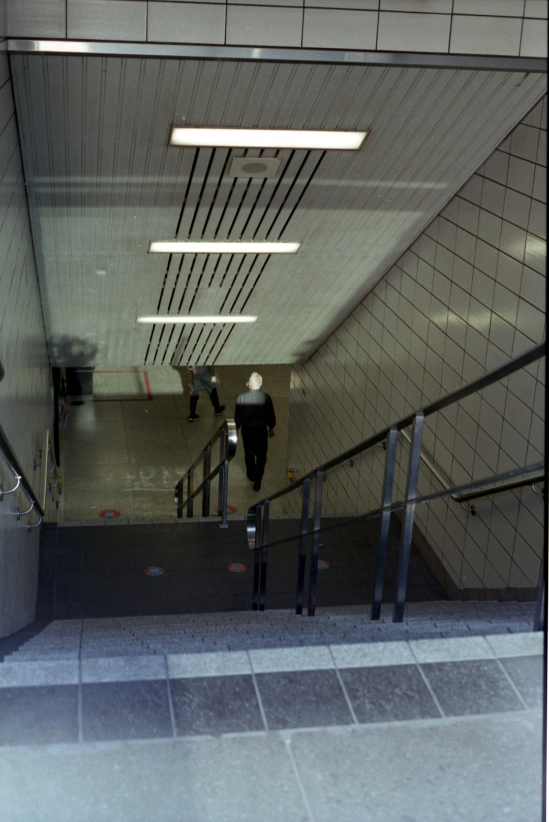 man in black jacket walking on hallway