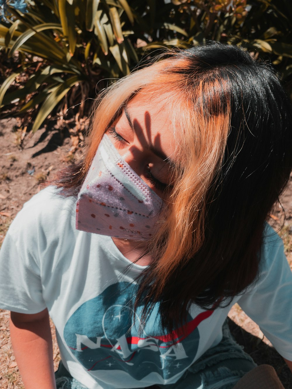 woman in white crew neck t-shirt with face mask