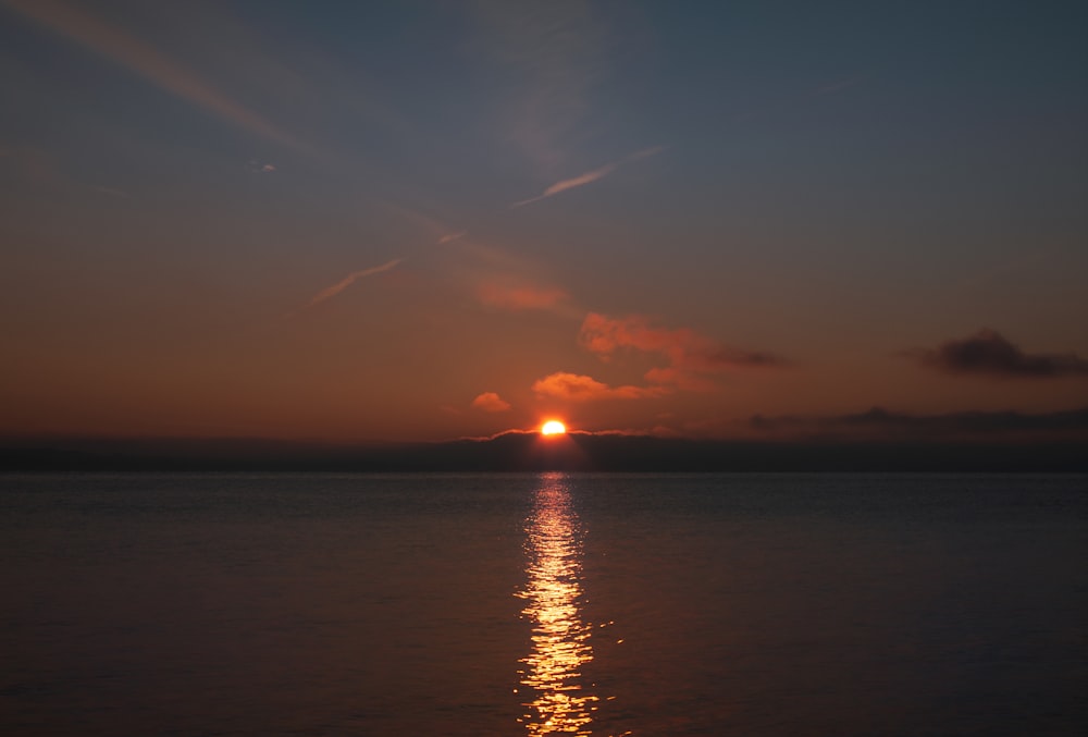 body of water during sunset