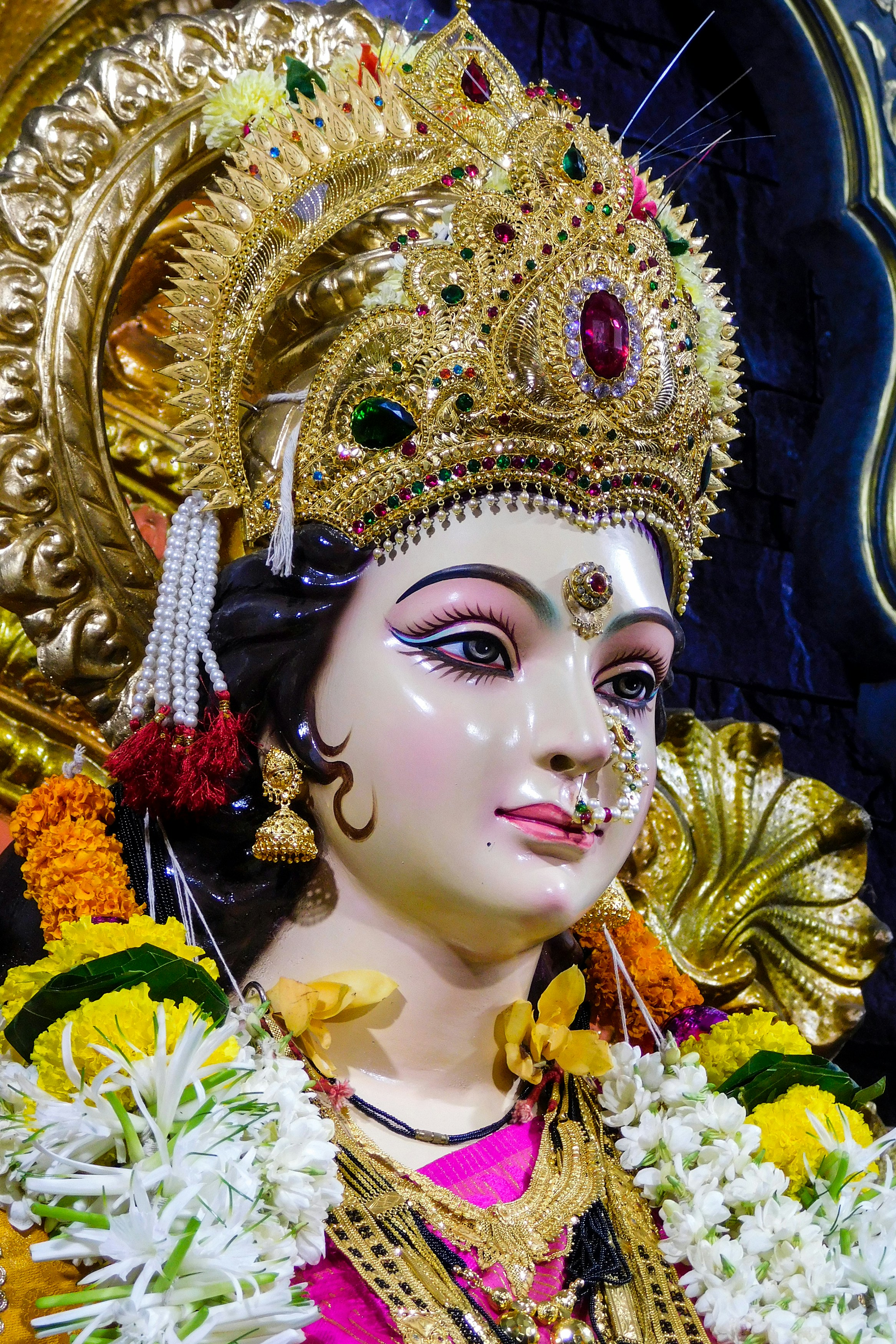 gold and white hindu deity figurine
