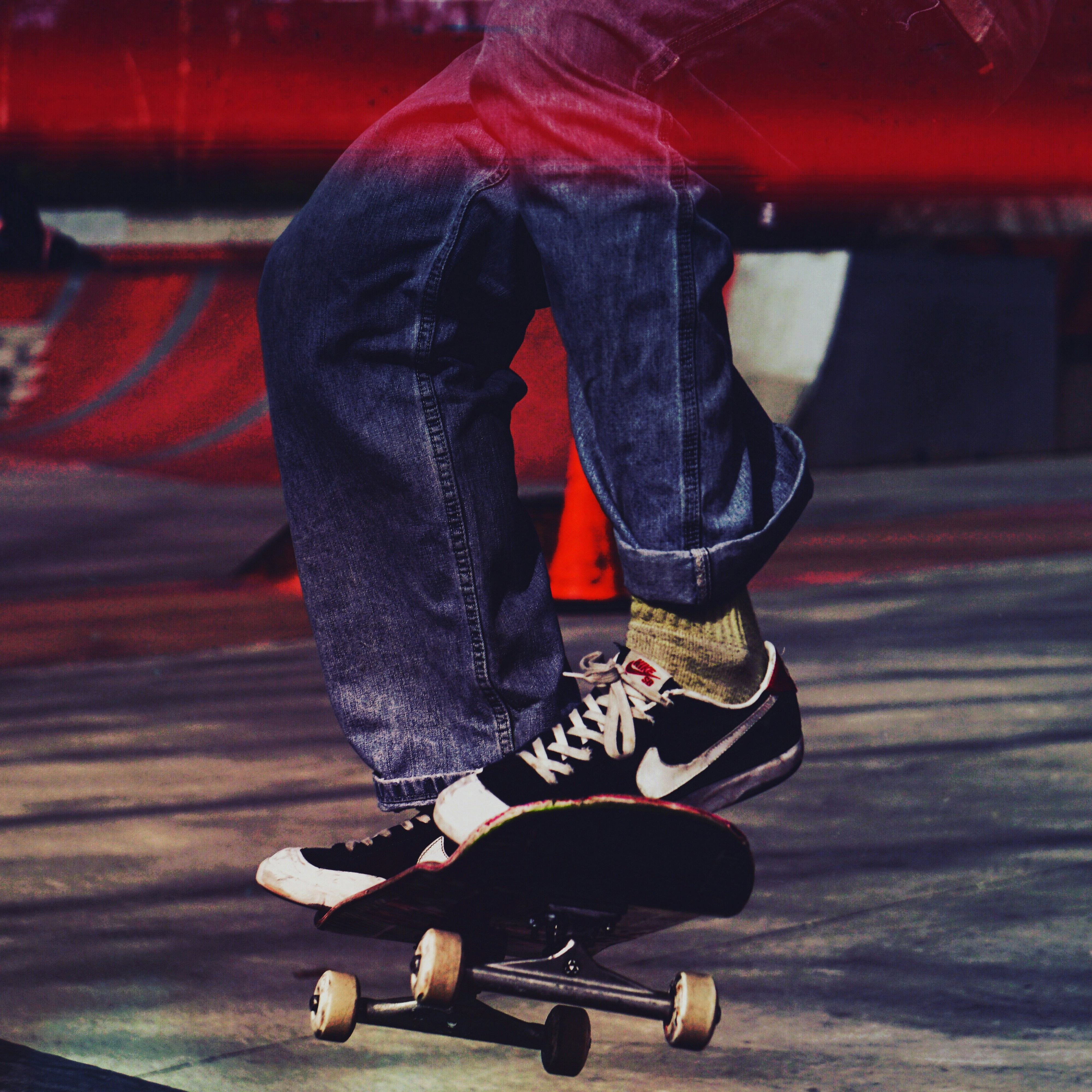 person in blue denim jeans and black and white nike sneakers