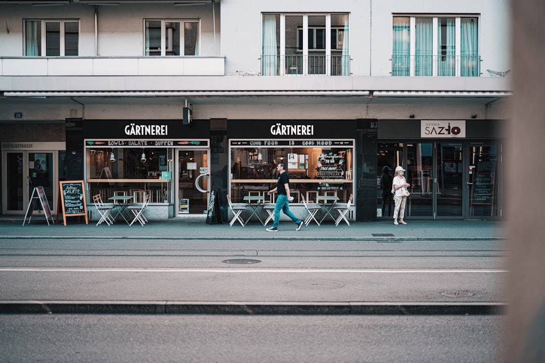 people walking on sidewalk near store during daytime